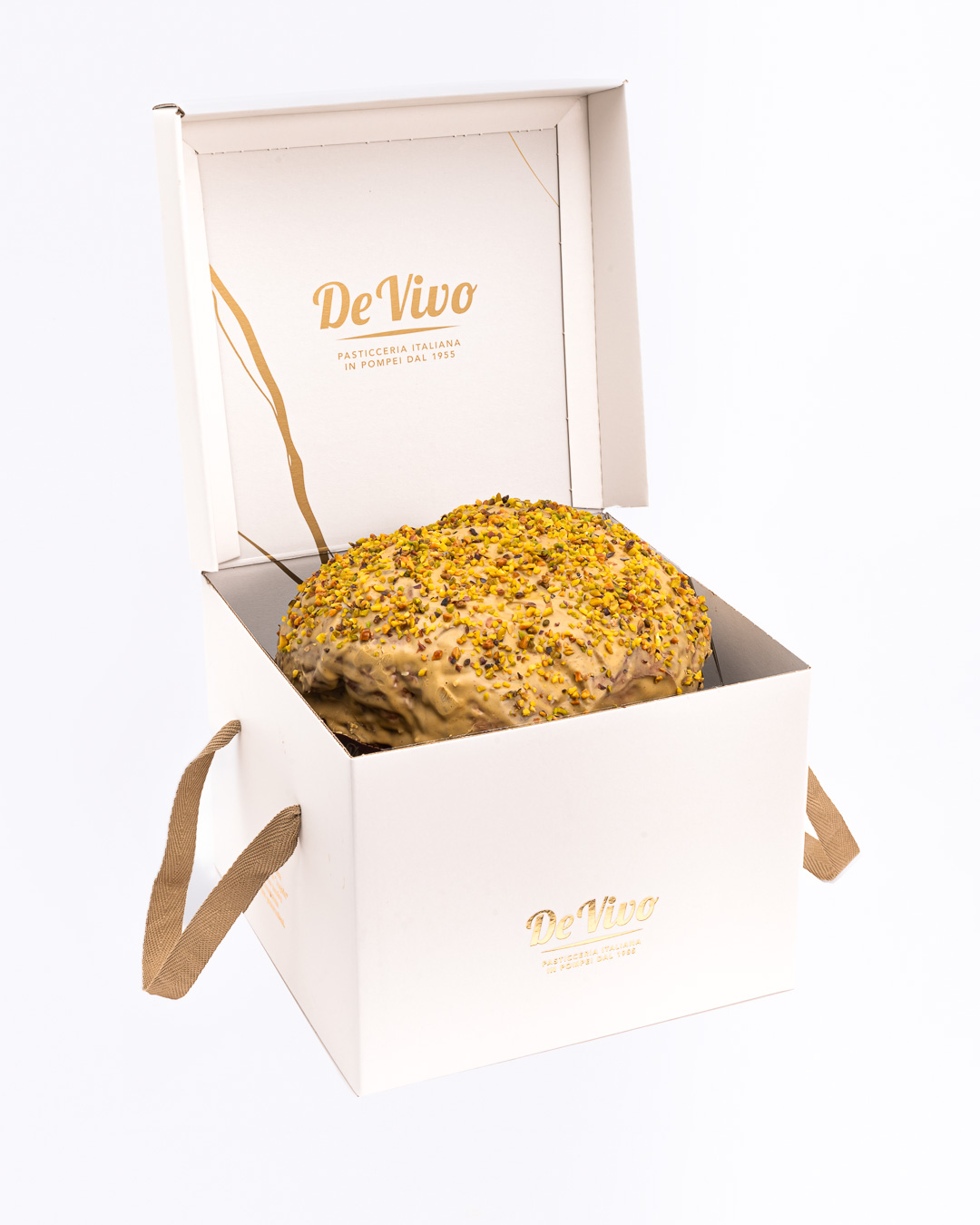Panettone Pistacho De Vivo – Caja Premium Panettone al pistacho de Pasticceria De Vivo en caja premium blanca abierta, con glaseado y granillo de pistacho, fotografía profesional para tienda gourmet.