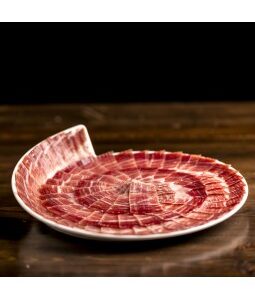 Jamón de bellota 100% ibérico cortado a cuchillo en plato con presentación circular