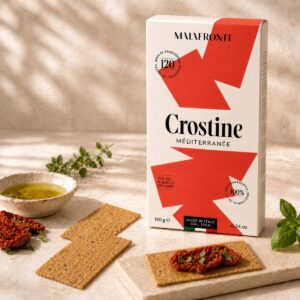 Crostine Mediterráneas Malafronte con aceite de oliva y tomate seco servidas con aceite, tomate seco y hierbas mediterráneas
